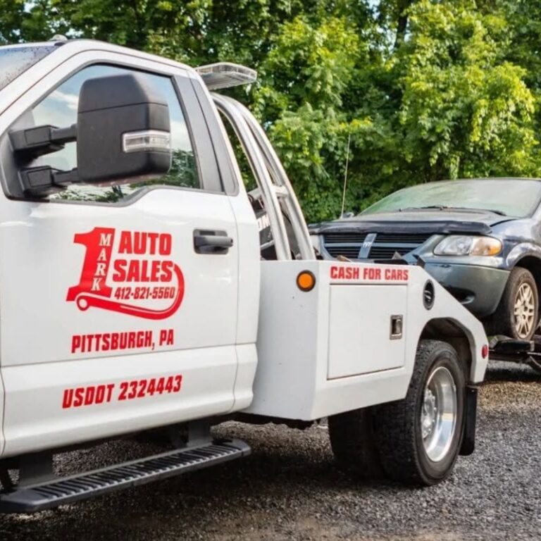 Flatbed tow truck safely loading a car for professional towing in Pittsburgh