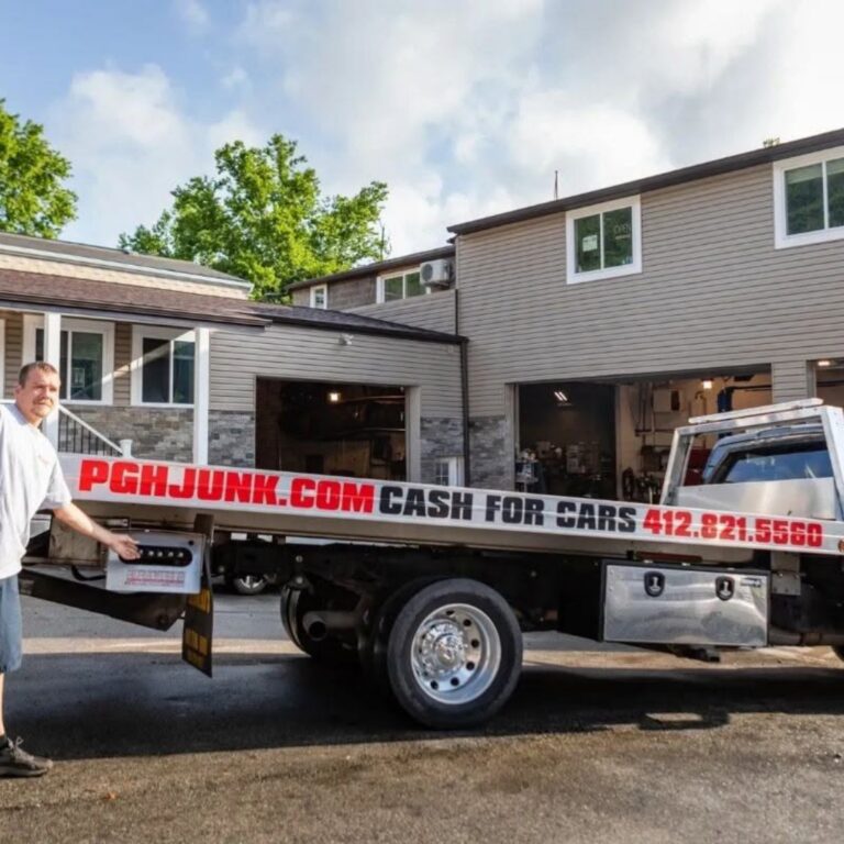 Tow truck picking up a junk car for free during a sale in Pittsburgh